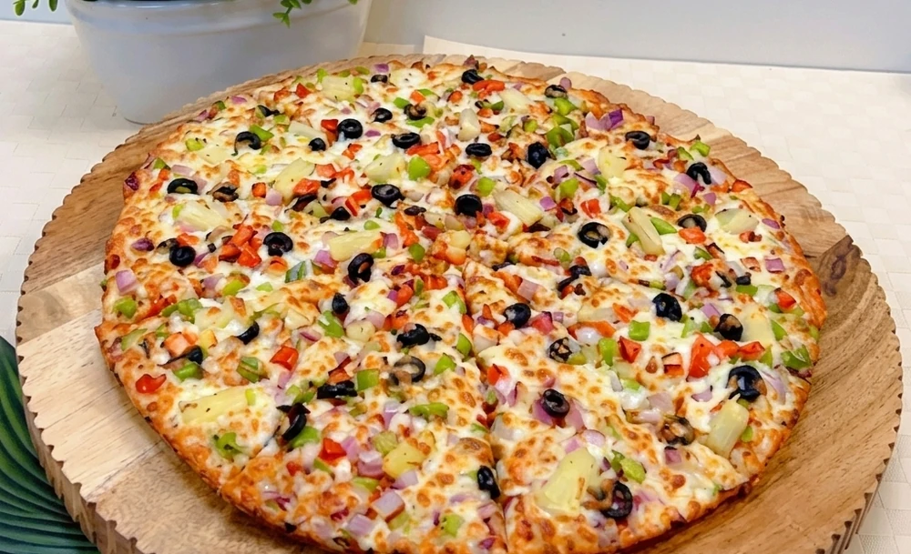 Veggie-loaded pizza with fresh vegetables at New Pizza Factory Edmonton